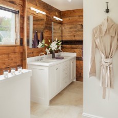 Wood is featured in the owners’ bath, contrasting with clean white custom cabinetry by Derek Preble Cabinetmakers