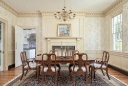 Ornate dining room with elaborate moldings and antique furniiture