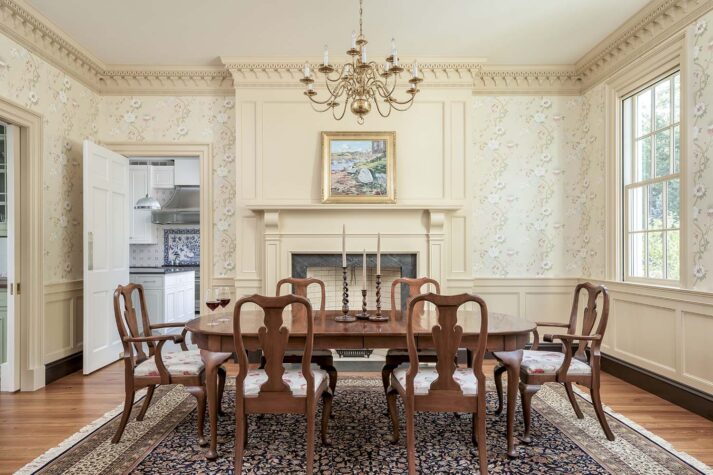 Ornate dining room with elaborate moldings and antique furniiture