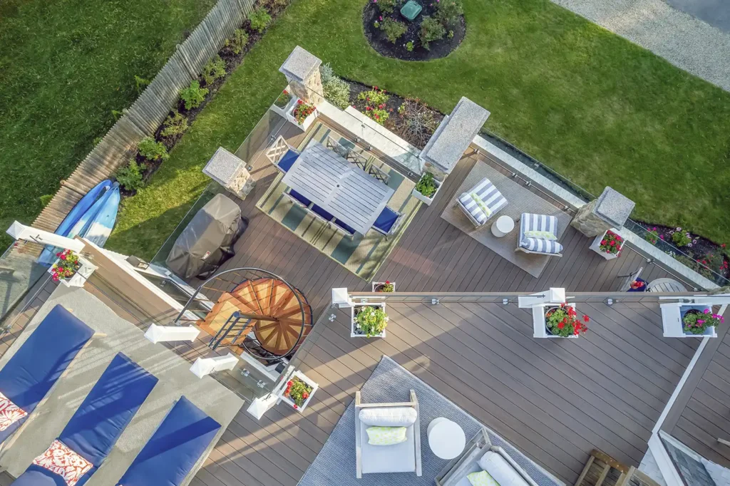 An aerial view shows the two decks—one on the second floor, the other on the third—joined by a custom spiral stair that technically serves as “fire escape.”